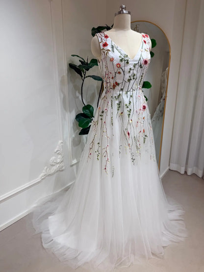 Viola A-line wedding dress with V-neck, featuring delicate pink and sage floral embroidery on airy white tulle.