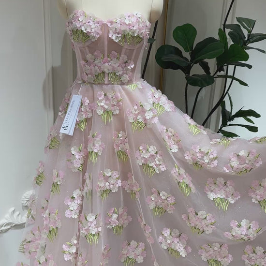 Model wearing the Elysia gown by Fleur&Grace Designs, a pink ankle-length dress made with 3D hydrangea floral lace, sparkly mesh lining, and lace-up back – perfect for prom, formal events, garden weddings, and whimsical photography.