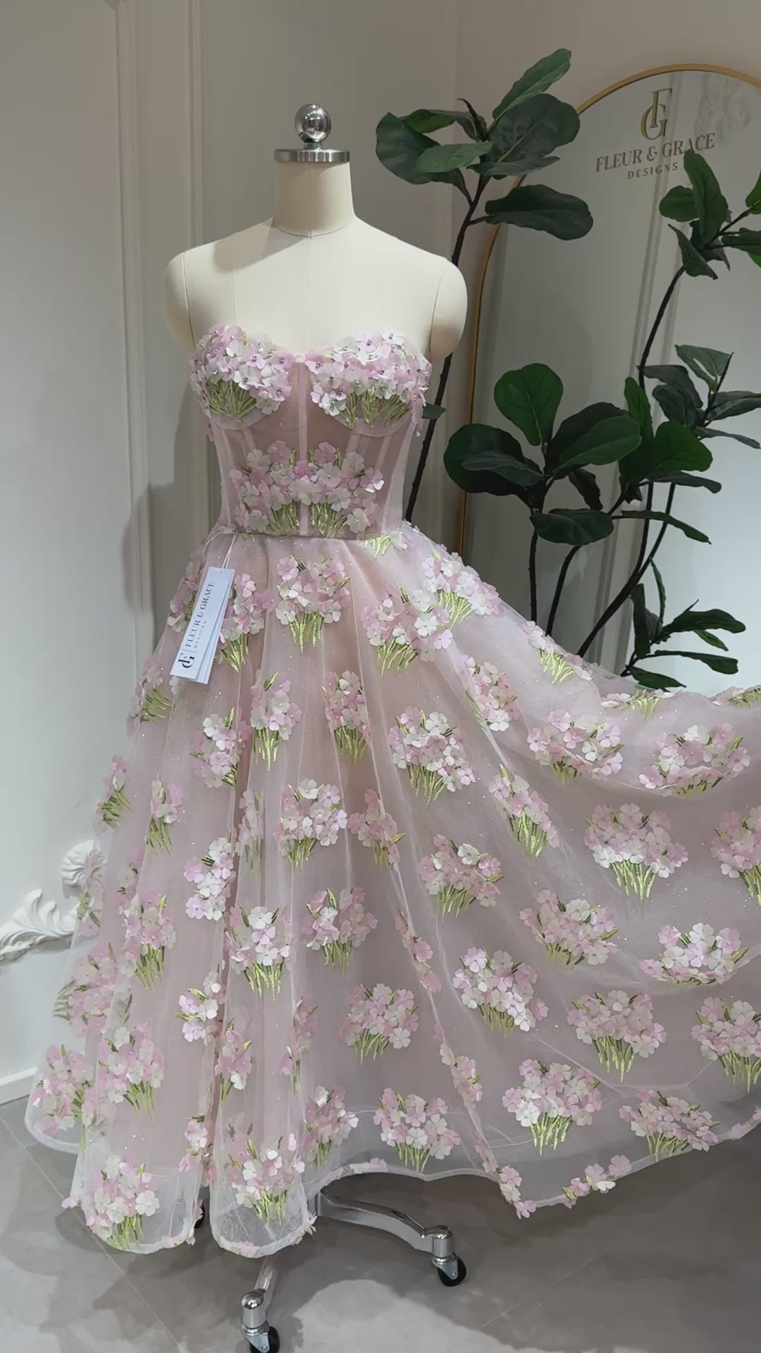 Model wearing the Elysia gown by Fleur&Grace Designs, a pink ankle-length dress made with 3D hydrangea floral lace, sparkly mesh lining, and lace-up back – perfect for prom, formal events, garden weddings, and whimsical photography.