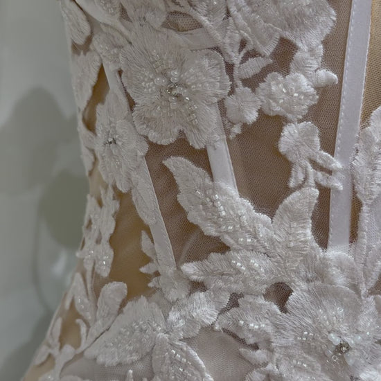 Tia Gown  by Fleur&Grace Designs — strapless mermaid wedding dress with basque waistline, sheer boned bodice, beige silk lining, ivory floral embroidery with beading, plunging V-neck, and court train.